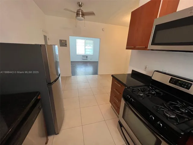a kitchen with granite countertop a stove and a refrigerator