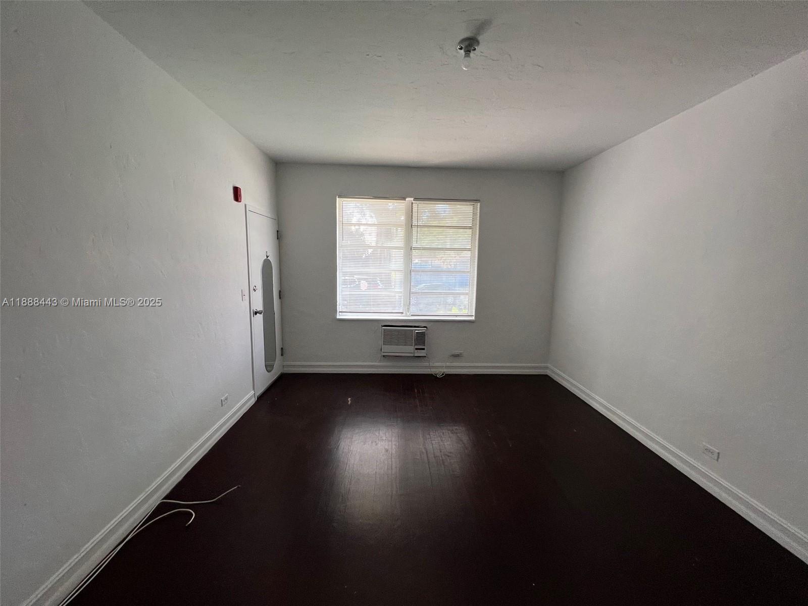 500 14th Street, Unit 105 Miami Beach, FL 33139 - Photo 6 of 10 an empty room with wooden floor and windows