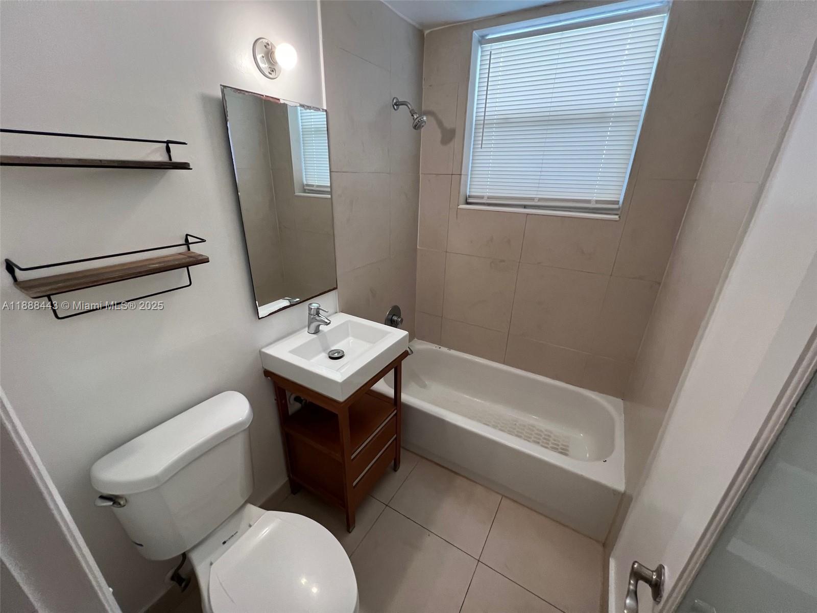500 14th Street, Unit 105 Miami Beach, FL 33139 - Photo 8 of 10 a bathroom with a sink toilet and shower