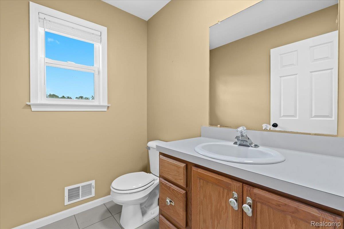 3778 Warner Road Howell, MI 48855 - Photo 11 of 38 Bathroom featuring light tile patterned flooring and vanity