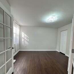3143 Clint Moore Road, Unit 107 Boca Raton, FL 33496 - Photo 13 of 28 wooden floor in an empty room with a window