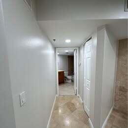 3143 Clint Moore Road, Unit 107 Boca Raton, FL 33496 - Photo 15 of 28 a view of a hallway to closet and a couch