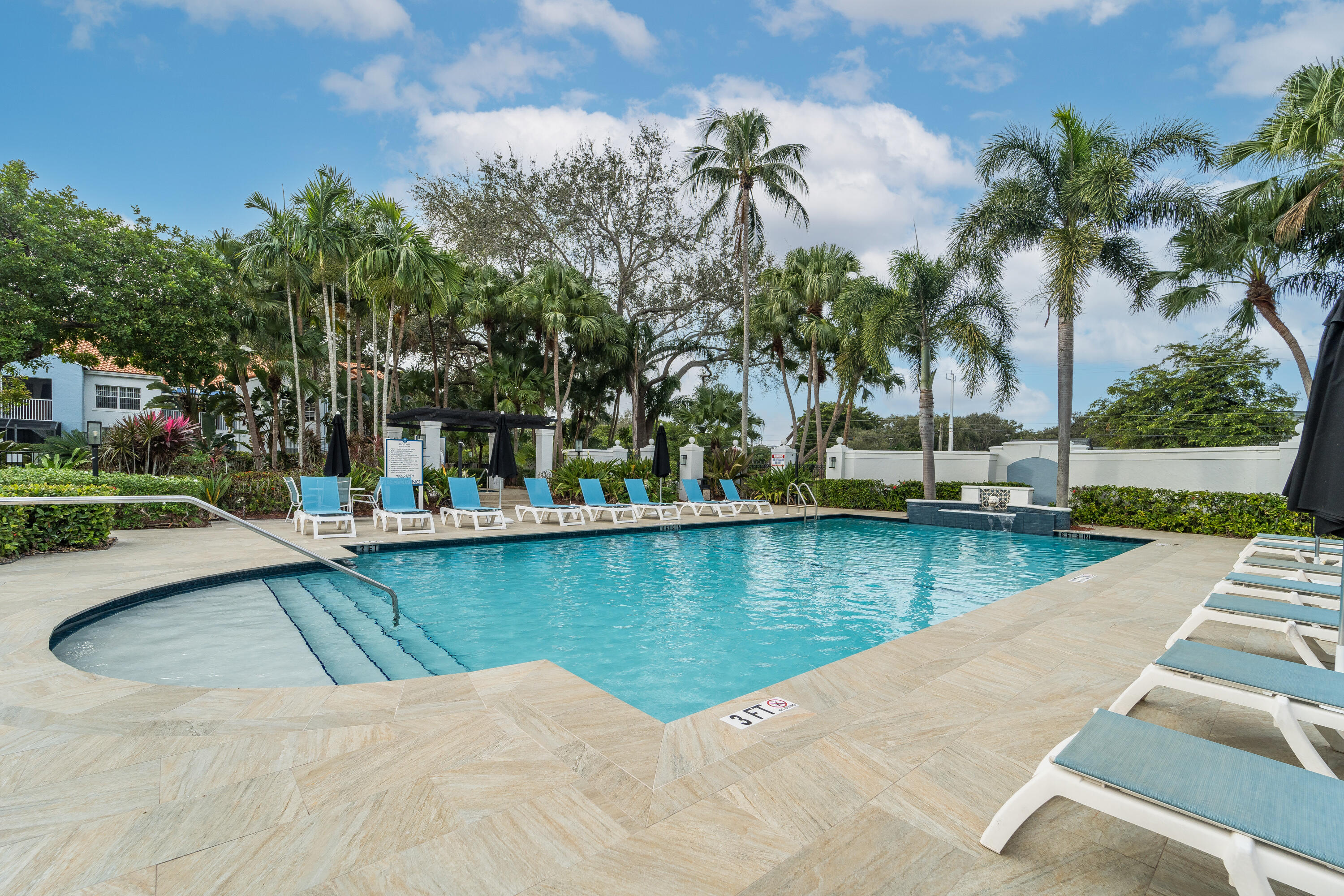 3143 Clint Moore Road, Unit 107 Boca Raton, FL 33496 - Photo 20 of 28 a view of a swimming pool with lounge chair