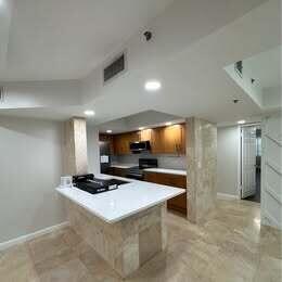 3143 Clint Moore Road, Unit 107 Boca Raton, FL 33496 - Photo 2 of 28 a kitchen with a stove a refrigerator and a sink