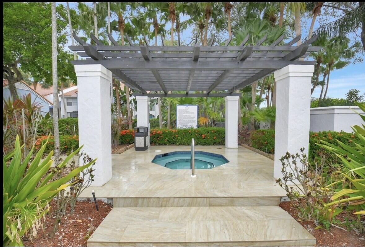 3143 Clint Moore Road, Unit 107 Boca Raton, FL 33496 - Photo 28 of 28 a view of a patio with table and chairs potted plants