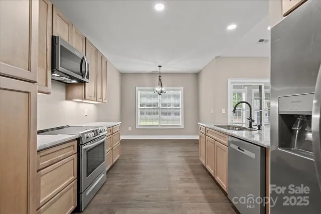 a kitchen with stainless steel appliances granite countertop a stove and a sink