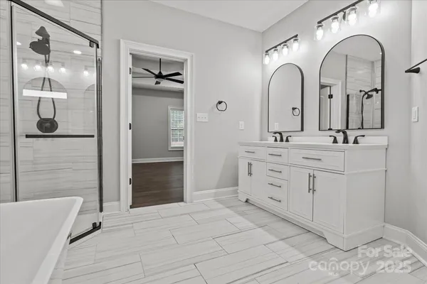 a bathroom with a double vanity sink and mirror