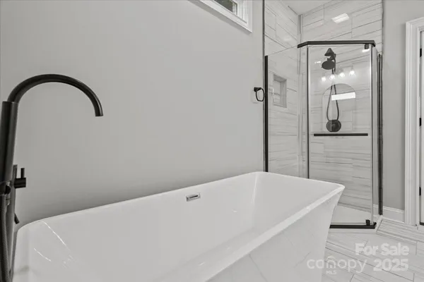 a bathroom with a bathtub and shower
