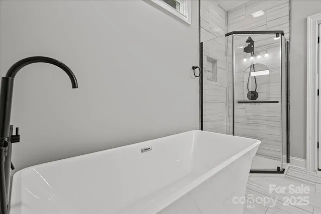 a bathroom with a bathtub and shower