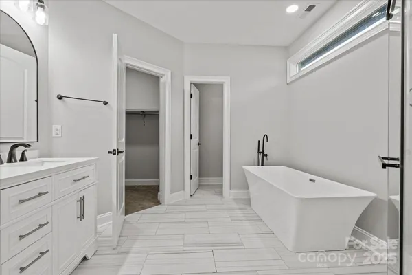 a spacious bathroom with a toilet sink and shower