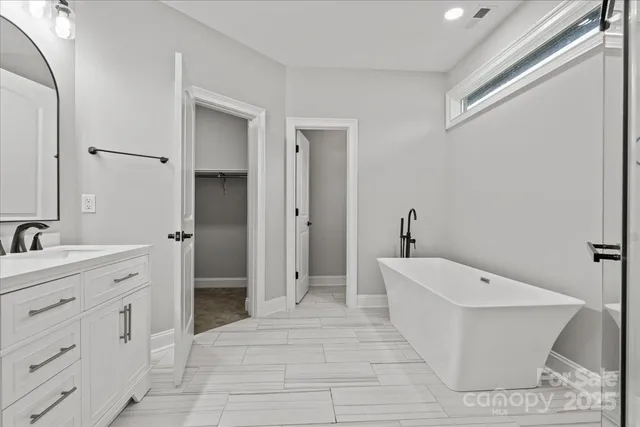 a spacious bathroom with a toilet sink and shower