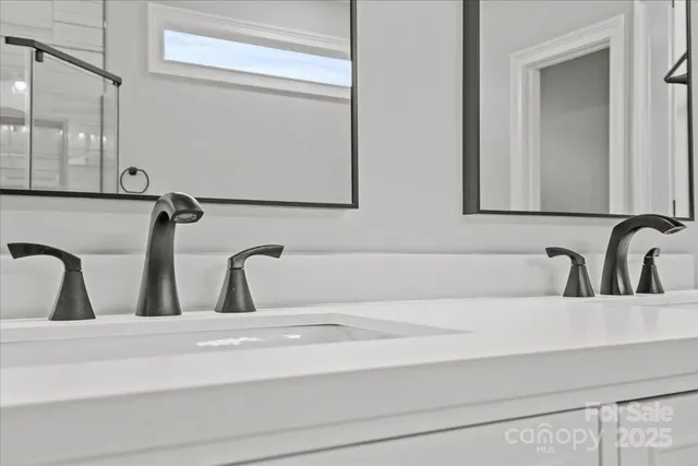 a bathroom with a double vanity sink