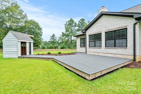 a view of a house with pool and sitting area