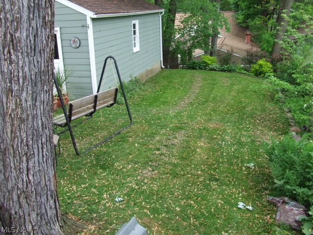 653 Ecton Road Akron, OH 44303 - Photo 21 of 25 View of backyard and part of garage from the deck.