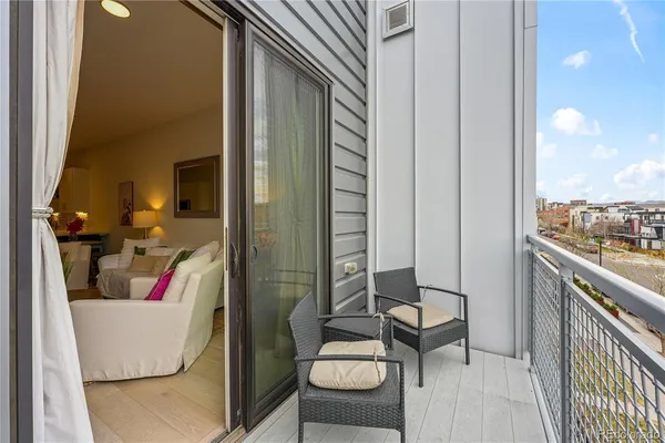 a balcony with couch and chairs