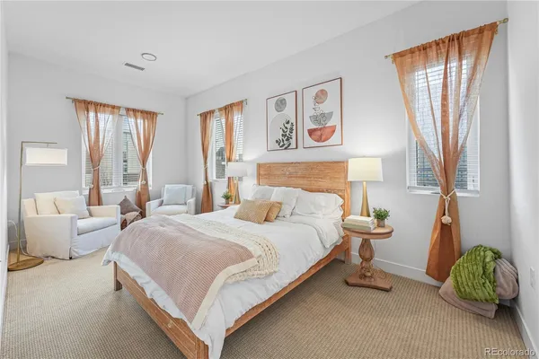 a bedroom with a bed and a couch