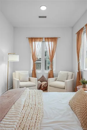 a bedroom with a large bed and a large window