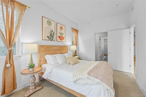 a bedroom with a bed and a painting on the wall