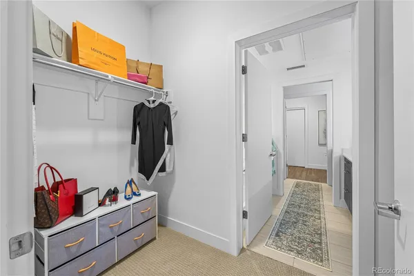 a view of a hallway with closet and toys