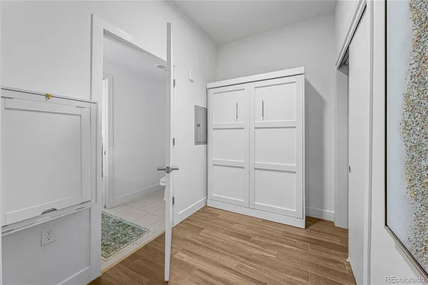 a bedroom with a bed and a potted plant