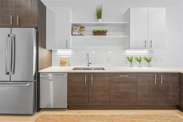 a kitchen with a sink and a refrigerator