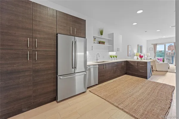 a kitchen with stainless steel appliances a refrigerator and a cabinets