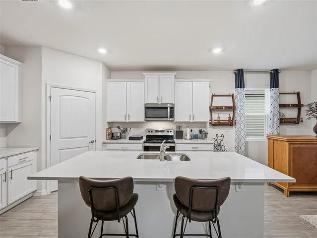 a living room with furniture a flat screen tv and a potted plant