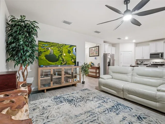 a bedroom with a bed and painting on the wall