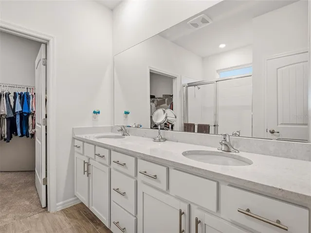 a view of walk in closet with clothes