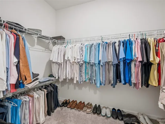 a bedroom with a bed and a table in it with window