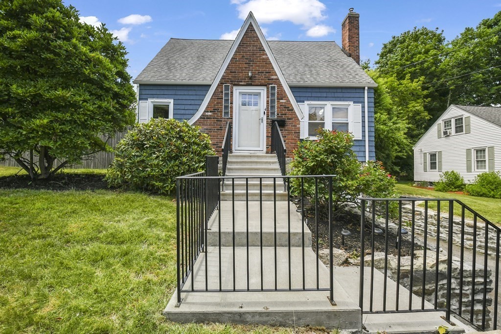 a front view of a house with a garden