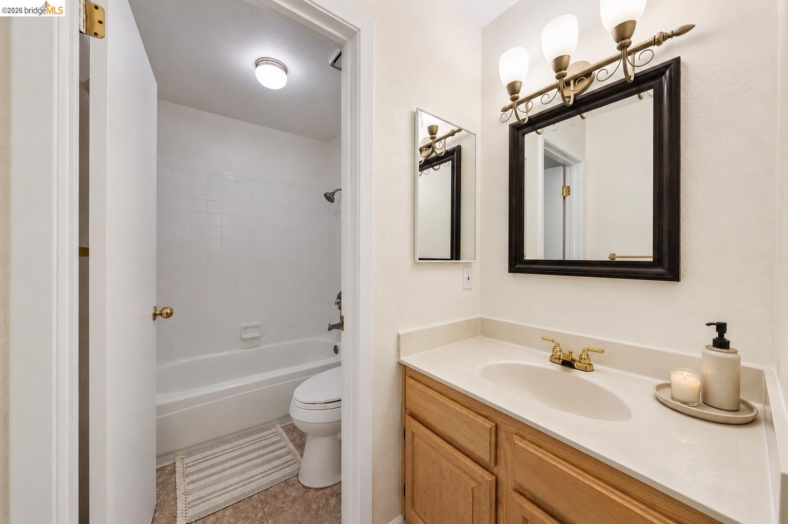 261 Redhawk Road Novato, CA 94949 - Photo 35 of 44 Bathroom featuring a vanity with a light-toned countertop, wood-finish cabinetry, and a gold-toned faucet