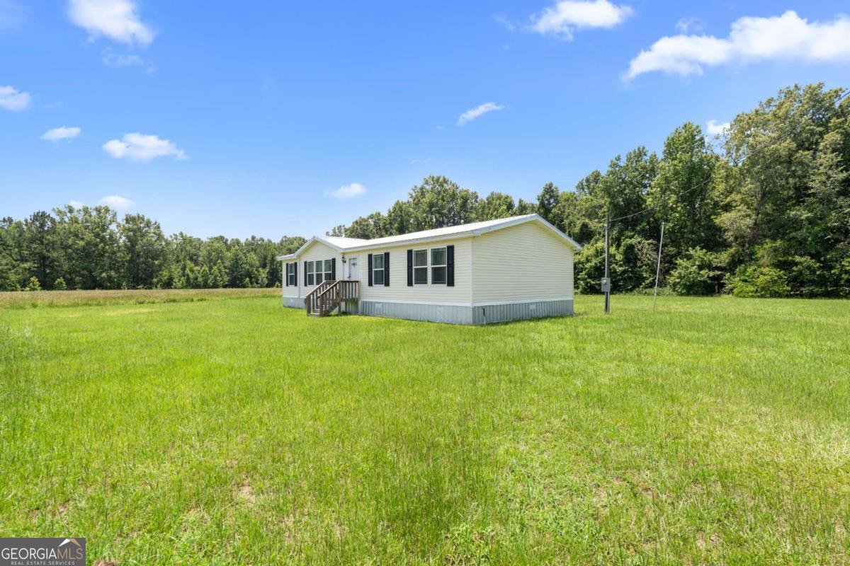 3516 Bennetts Landing Road Millen, GA 30442 - Photo 5 of 34 a view of a house with a backyard