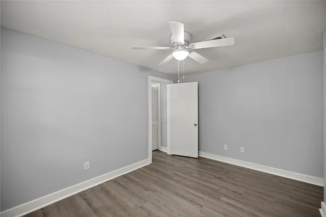 a view of an empty room with wooden floor