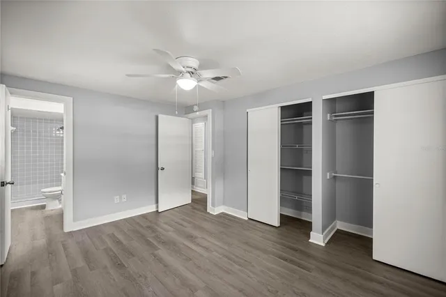 an empty room with wooden floor and window