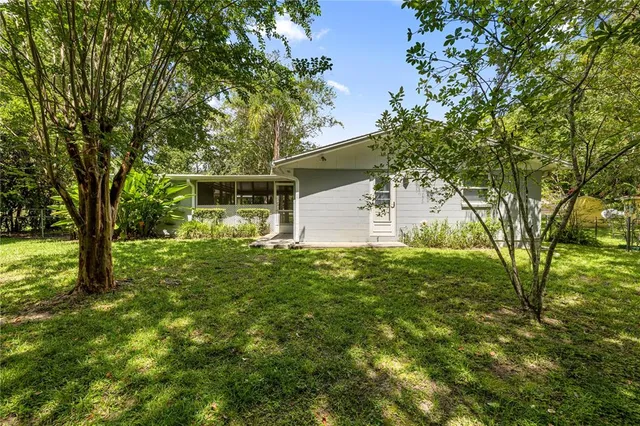 a backyard of a house with table and chairs