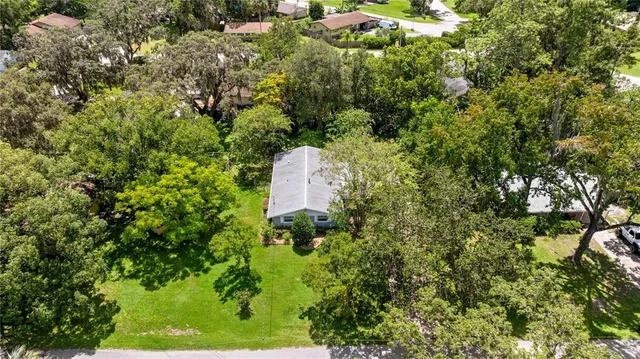 an aerial view of a house with a yard