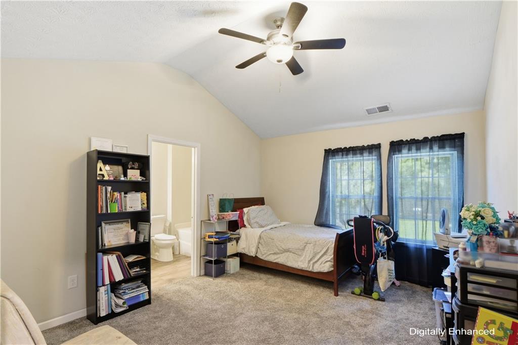 2555 Flat Shoals Road, Unit 2008 Atlanta, GA 30349 - Photo 18 of 33 a bedroom with furniture and a large window