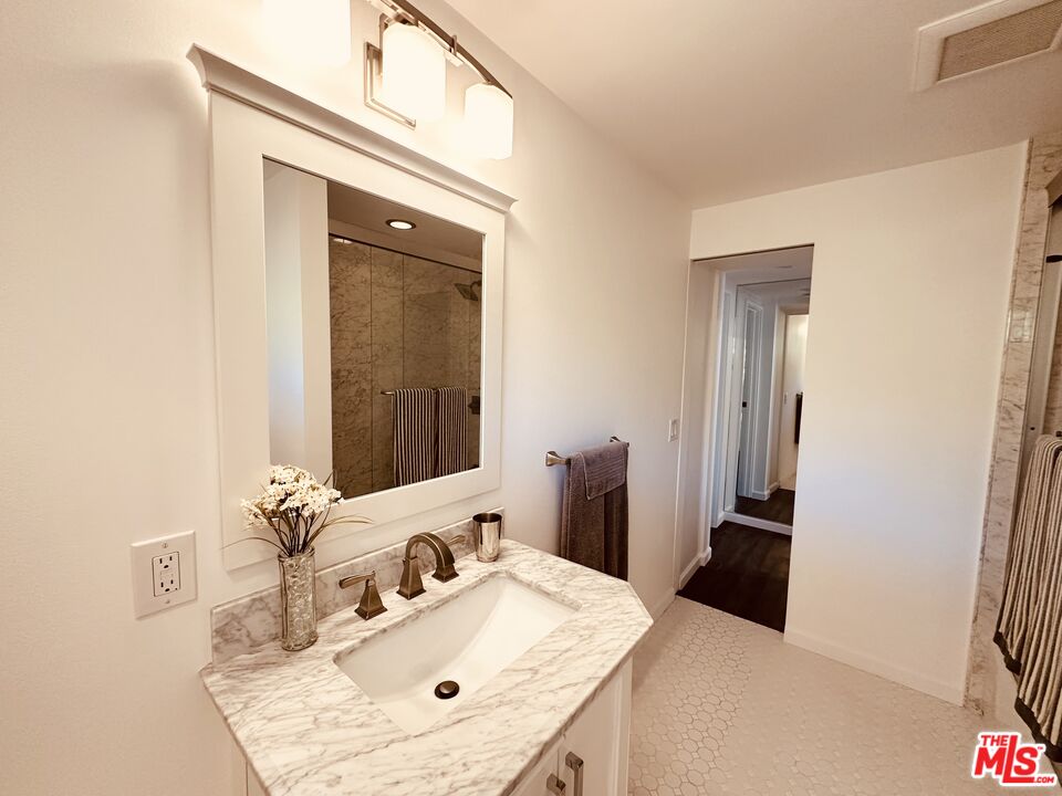 2039 Tuna Canyon Road, Unit B Topanga, CA 90290 - Photo 12 of 19 a bathroom with a sink vanity granite and a mirror