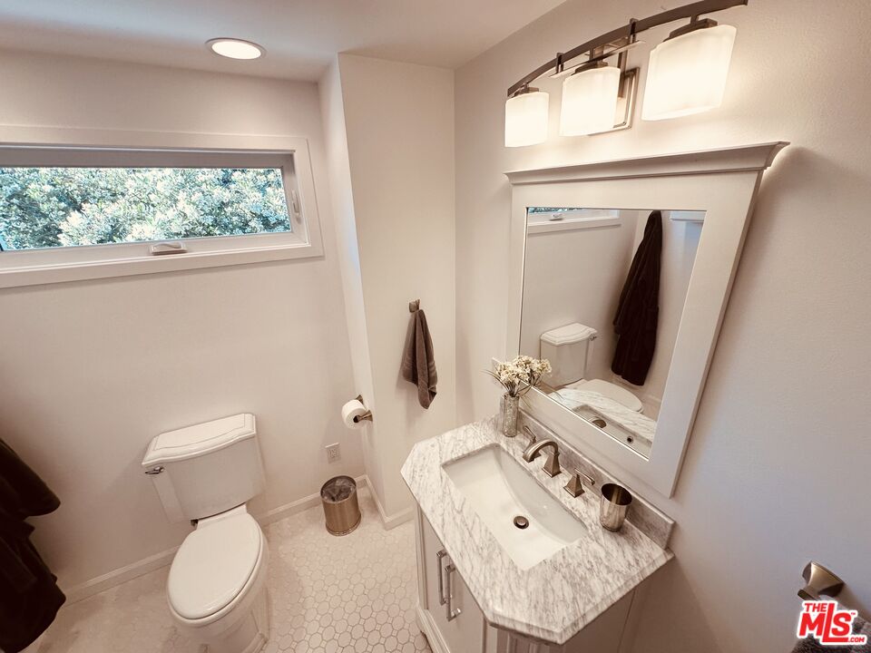 2039 Tuna Canyon Road, Unit B Topanga, CA 90290 - Photo 13 of 19 a bathroom with a toilet sink and mirror