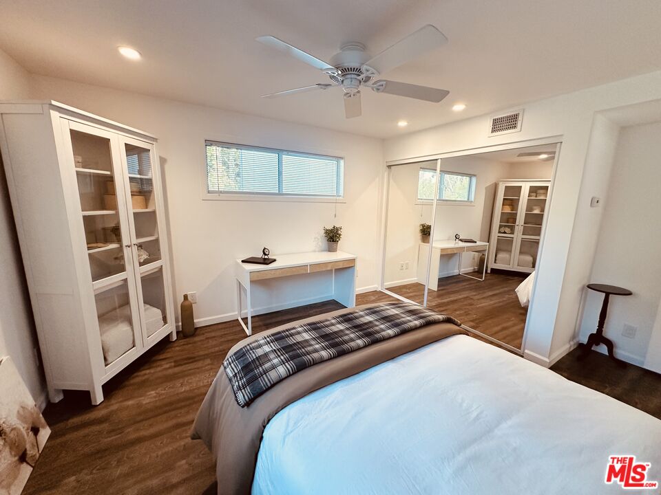 2039 Tuna Canyon Road, Unit B Topanga, CA 90290 - Photo 18 of 19 a bedroom with a bed and wooden floor