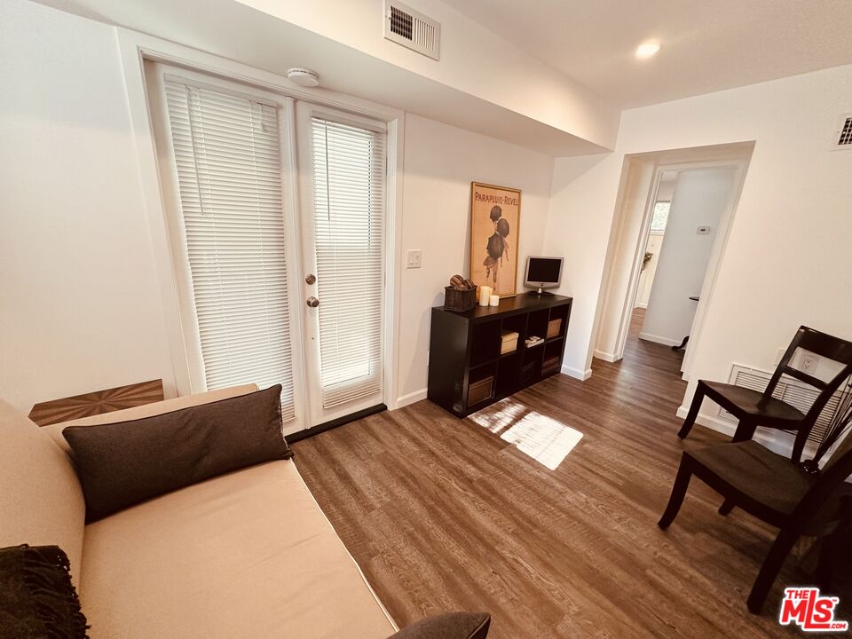 2039 Tuna Canyon Road, Unit B Topanga, CA 90290 - Photo 2 of 19 a bedroom with a bed and wooden floor