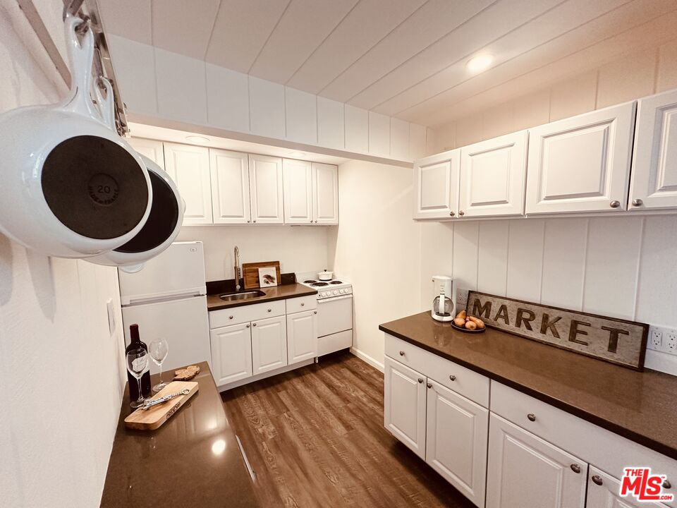2039 Tuna Canyon Road, Unit B Topanga, CA 90290 - Photo 7 of 19 a kitchen with granite countertop a sink a stove and cabinets