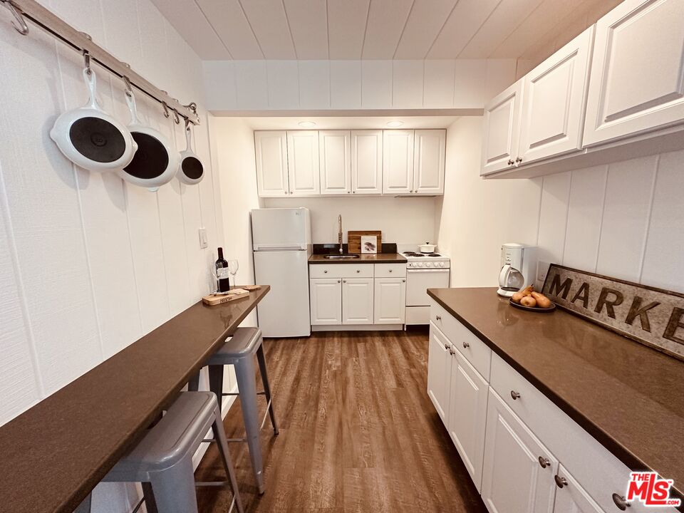 2039 Tuna Canyon Road, Unit B Topanga, CA 90290 - Photo 8 of 19 a kitchen with kitchen island stainless steel appliances a stove a sink and a refrigerator