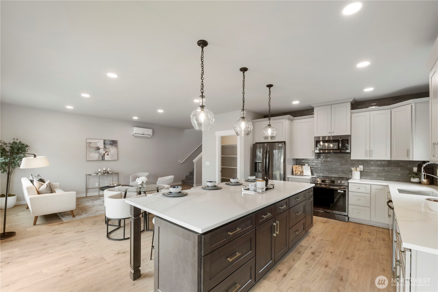 528 Harman Way South Orting, WA 98360 - Photo 11 of 30 a large kitchen with kitchen island a sink stainless steel appliances and cabinets