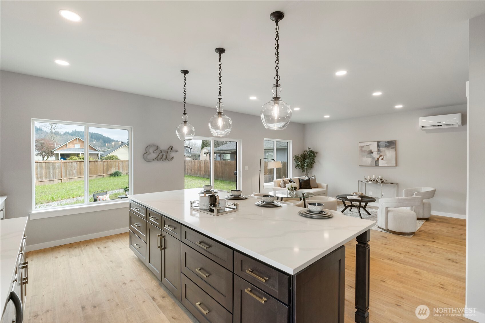 528 Harman Way South Orting, WA 98360 - Photo 12 of 30 a kitchen with stainless steel appliances kitchen island granite countertop a sink a stove and a wooden floors