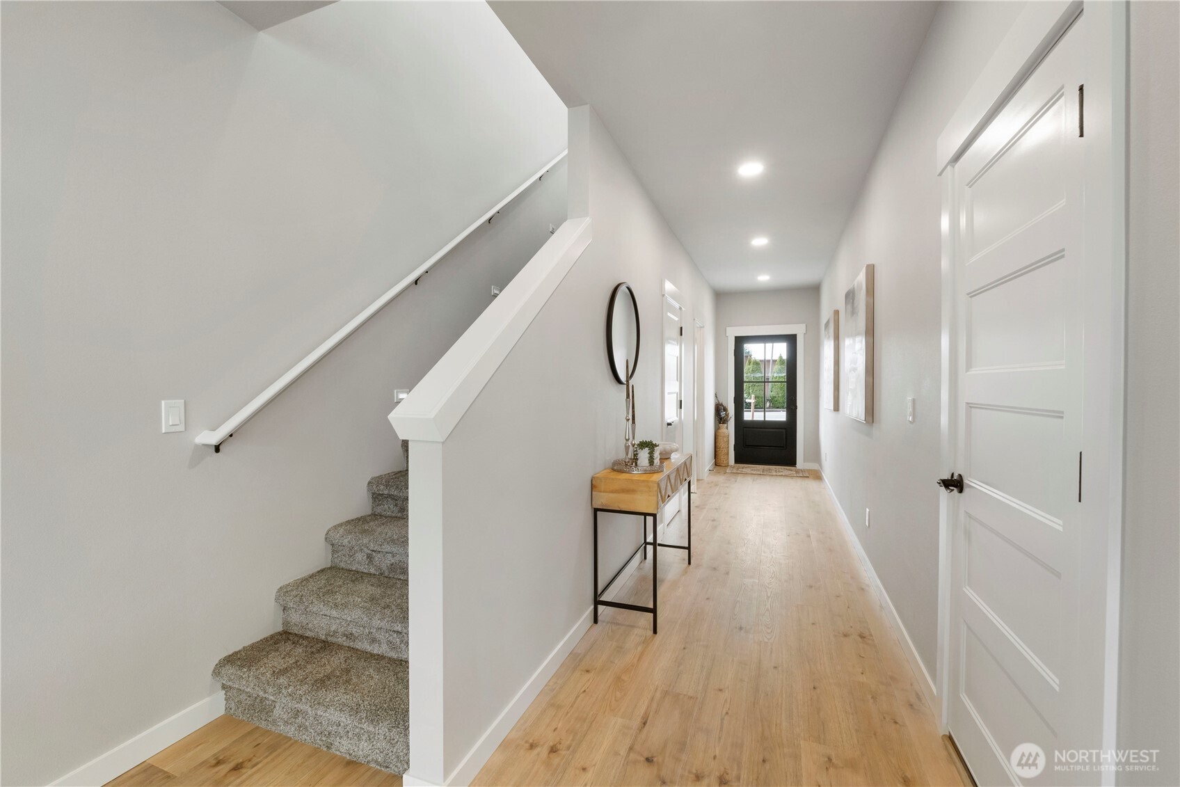 528 Harman Way South Orting, WA 98360 - Photo 14 of 30 a view of a hallway with wooden floor and staircase