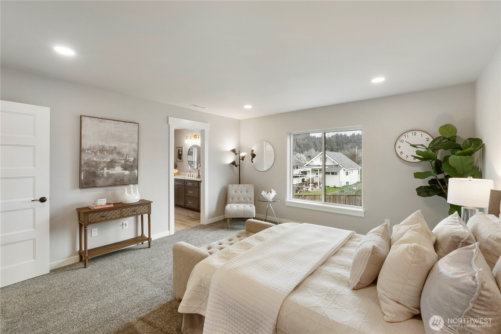 528 Harman Way South Orting, WA 98360 - Photo 17 of 30 a bedroom with a large bed and a chandelier