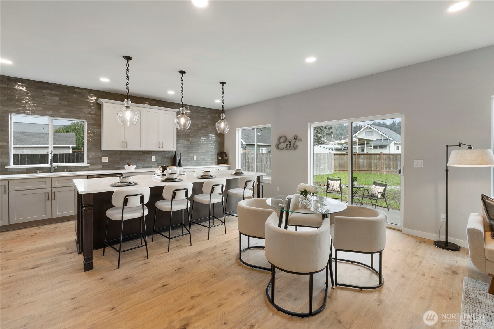 528 Harman Way South Orting, WA 98360 - Photo 8 of 30 a living room with stainless steel appliances kitchen island granite countertop furniture and a wooden floor