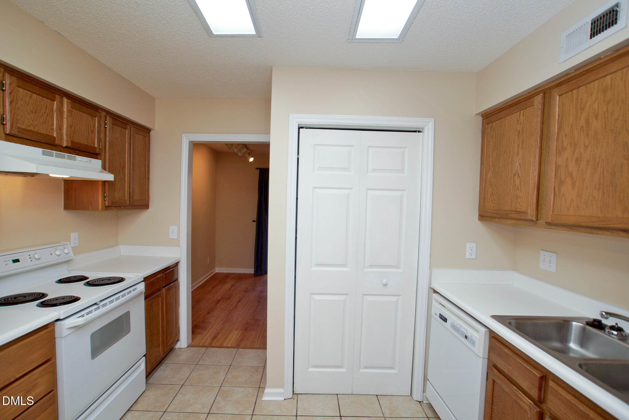 4101 Five Oaks Drive, Unit 10 Durham, NC 27707 - Photo 11 of 29 a kitchen with a sink cabinets and a stove